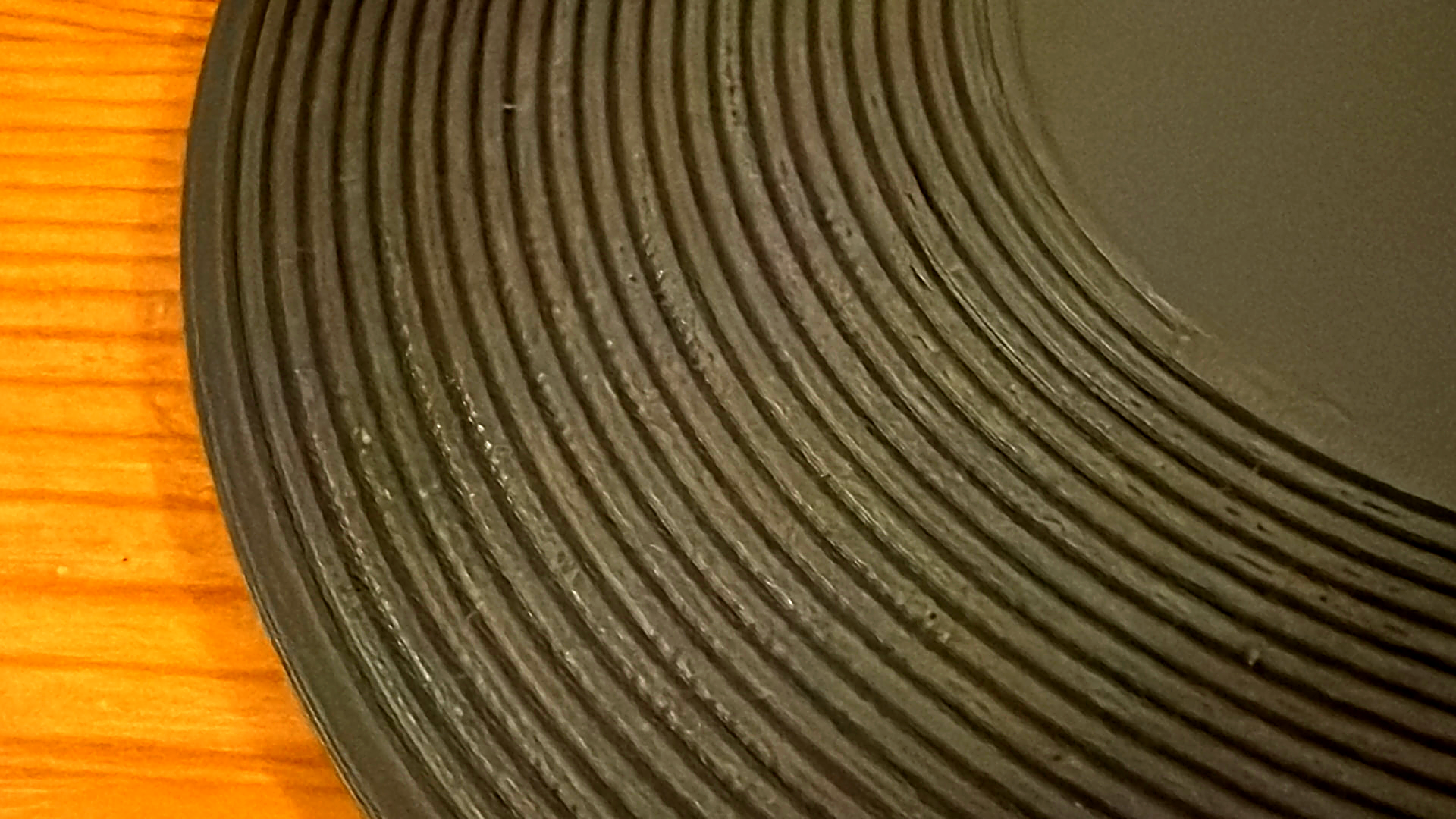 Macro photo of a grey Kräftsound development print showing crisp printed groove walls